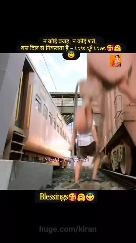 Young boy comforting a baby near train tracks and coal, conveying love and blessings.