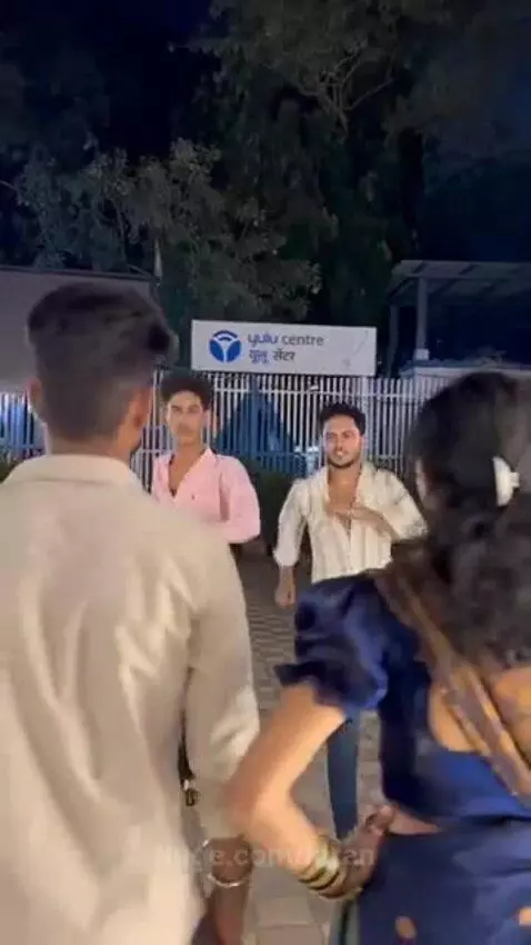 Person in a blue saree dancing at night, then being assaulted by young men.