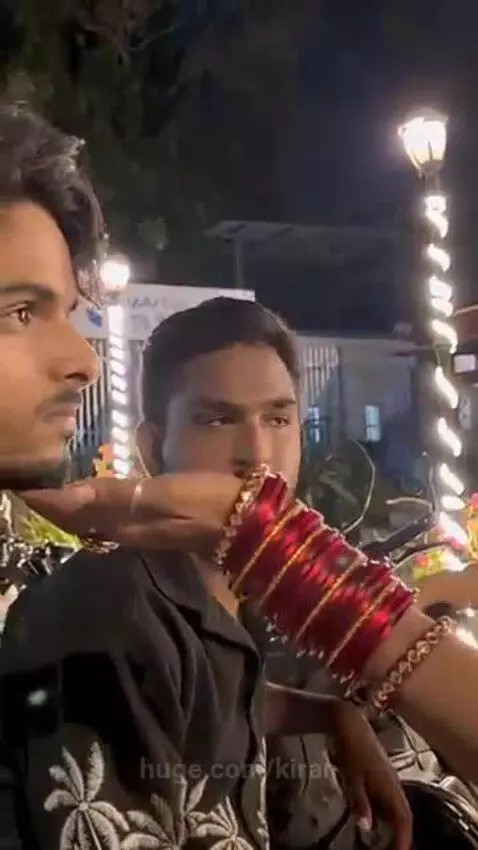 Person in a red saree smiling warmly at a young man, conveying a message of hope.