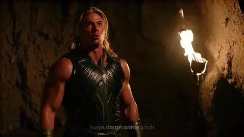 Muscular He-Man in armor in a dimly lit cave, speaking with determination about becoming rich.