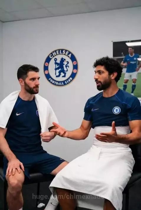 Two Chelsea FC players in kits in a locker room, discussing football and their 'world champions' status.