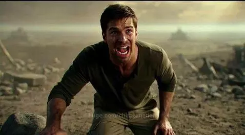 Man with tears, shouting in a desolate, dusty landscape with ruins in the background.