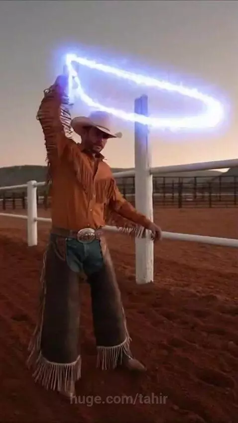 Cowboy in a rodeo arena twirling a glowing blue laser lasso.