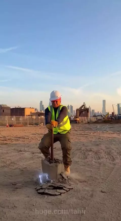 Man in hard hat and vest on construction site as a skyscraper instantly grows from a pipe.