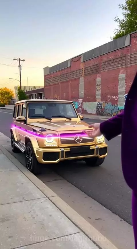 Man in purple suit with pink hair transforms a rusty teal car into a gold Mercedes G-Wagon.