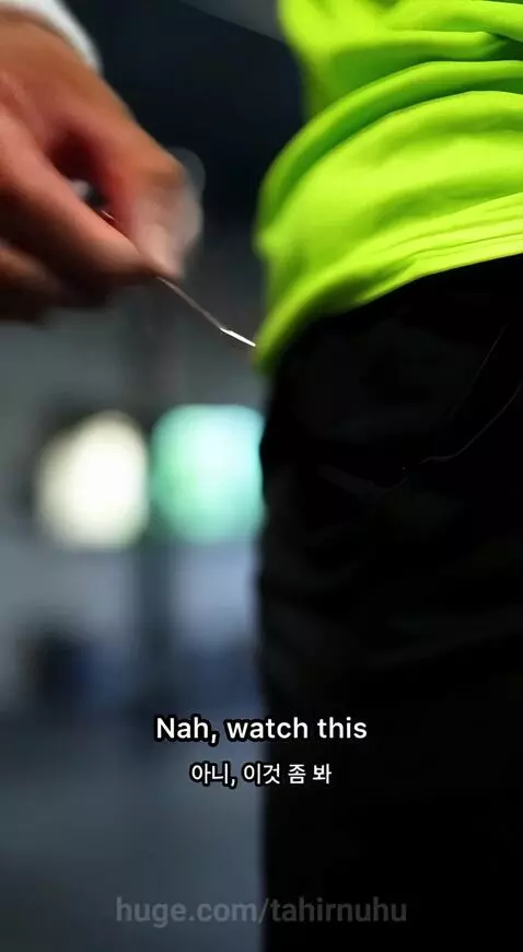 Muscular man with pink hair lifting a blue car with one arm in a gym setting.