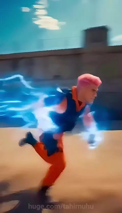 Man with pink hair and electrical powers in an orange jumpsuit fighting armed guards in a prison yard.