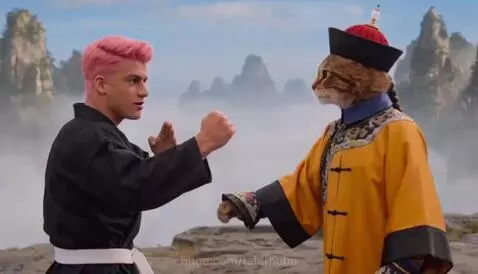 A cat in Chinese martial arts clothing and a man in a gi on a mountain peak, followed by the cat firing a machine gun from a jeep.