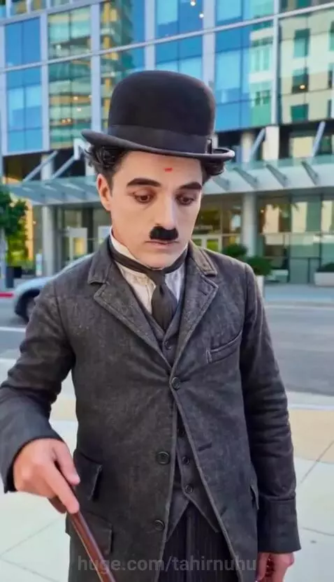 Charlie Chaplin character spills coffee, revealing a man's multiple smartwatches that start beeping.