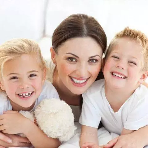 Montage of mothers and children sharing joyful and affectionate moments, playing and cuddling.