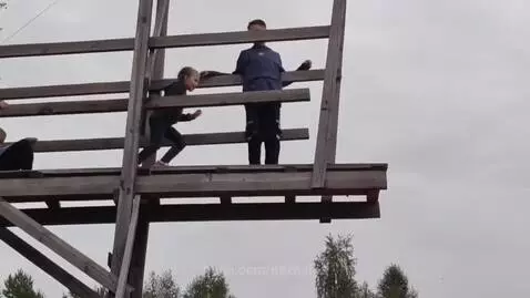 An 8-year-old girl smiles after bravely jumping onto a large inflatable airbag.