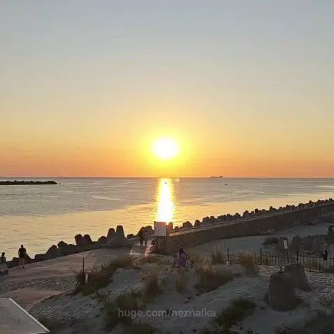Panoramic view of Kaliningrad coastline with a sunset over the Baltic Sea and the Curonian Spit.