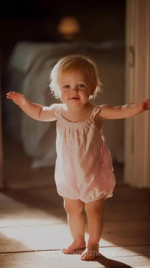 Older woman looks at phone showing a picture of a young girl, symbolizing connection across distance.