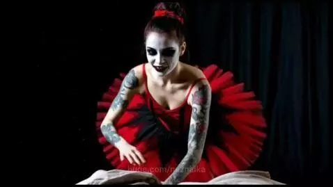 Woman in skull makeup and red/black tutu dancing in a dark, mystical forest setting.