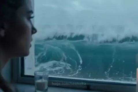 Woman looking out a rainy window, symbolizing sadness and heartbreak.