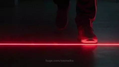 Person standing on a glowing red line that expands to show people in red cages, symbolizing restrictions.