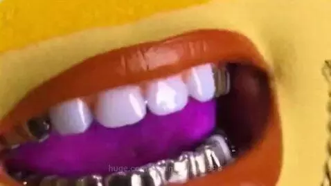 Animated character with sunglasses and gold chain rapping next to a bag of Super Sour Splaat Snacks.