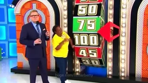The Price Is Right host and a contestant look concerned as the show's large spinning wheel appears to be stuck.