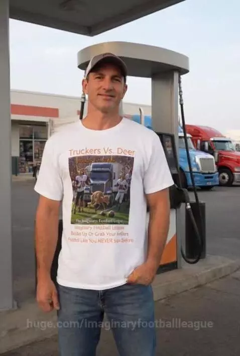 Man in 'Truckers Vs. Deer' t-shirt smiling at a truck stop with semi-trucks in the background.
