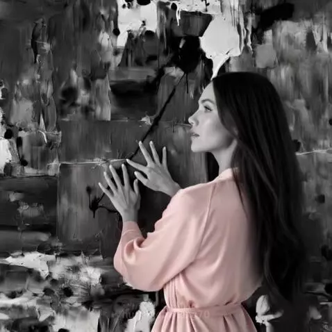 Woman in a pink robe touching an abstract painting, with the paint stretching to engulf her.