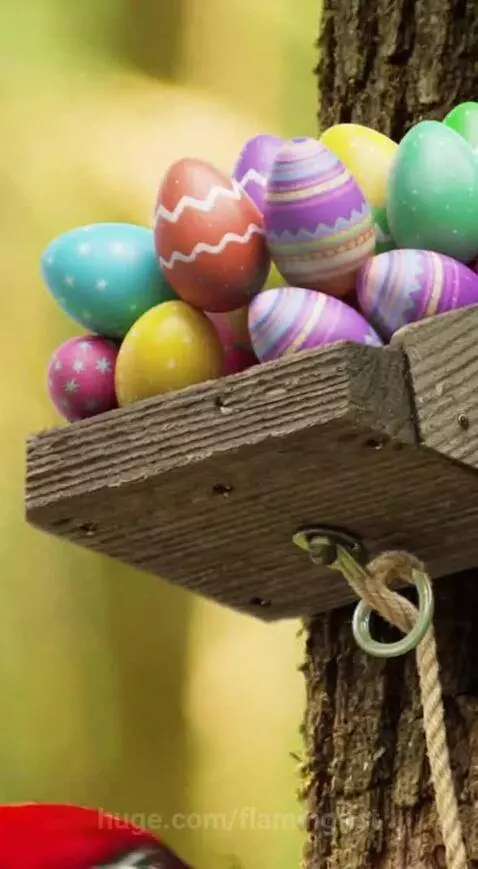 Animated squirrel pulling a shelf of Easter eggs, causing them to fall near a woodpecker.