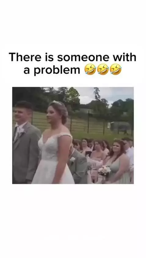 Bride and groom at wedding altar as a cow moos loudly in the background behind a fence.