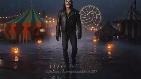 Man with clown makeup and dark clothing in a foggy carnival at night with string lights and jack-o'-lanterns.