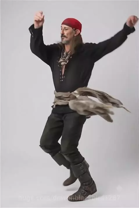 Man dressed as a pirate dancing energetically in a studio with a white background.