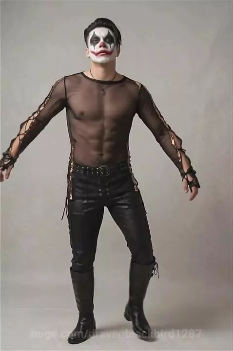 Man with clown makeup, black sheer top, and studded leather pants posing against a plain background.