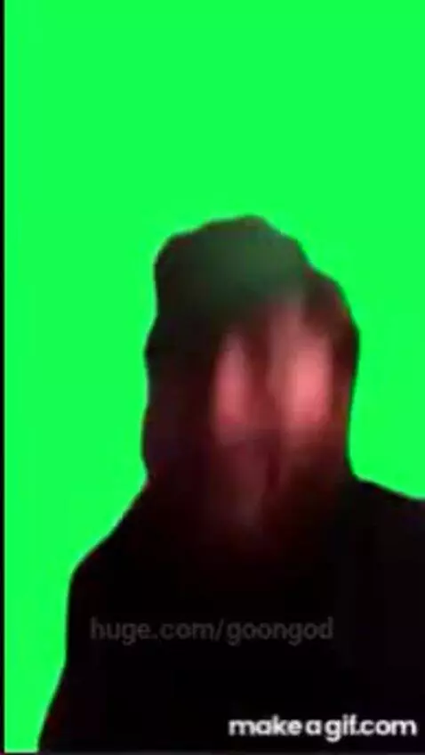 Man with beard and green hat points orange toy gun at camera, looking surprised against a green screen with flashing red and orange effects.