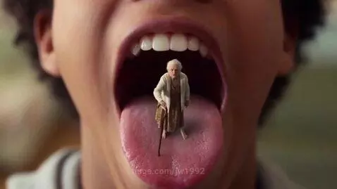 Close-up of a young person's open mouth with a tiny elderly woman standing on their tongue, holding a cane.