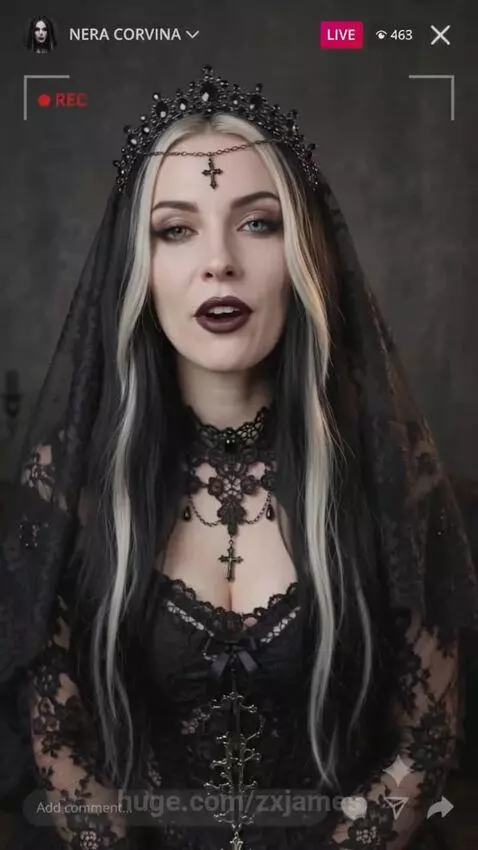 Nera Corvina in a black lace gothic gown with striking black and white hair, dark makeup, and heterochromia.