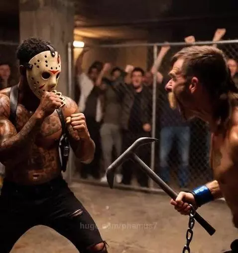 Two muscular men fighting intensely in a cage, one masked, the other shirtless with weapons.