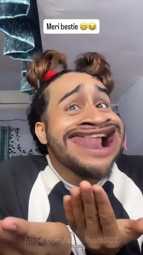 Man with wide eyes and large mouth face filter, hair in buns, wearing a pink flower earring, making funny expressions.