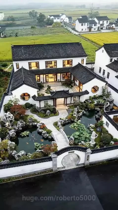 Aerial time-lapse of a traditional Chinese house and garden construction, showing landscaping and water features.