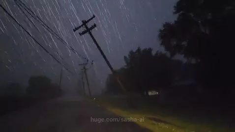 Dark stormy night with heavy rain, power flashes, and a leaning power pole.