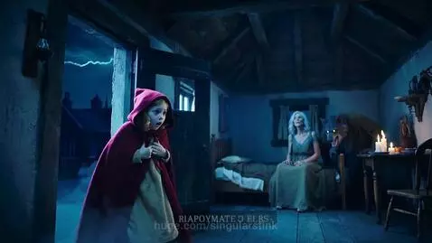 Little Red Riding Hood startled in a dark cottage as two people transform into wolf-like creatures with glowing eyes.