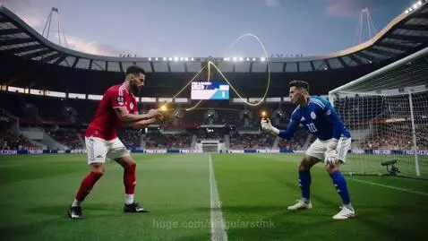 Soccer striker and goalkeeper facing each other on a field, holding smartphones with holographic lines connecting them in a stadium.