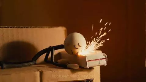 Stop-motion animation of a matchstick character in a cardboard house, with sparks and a retro TV.