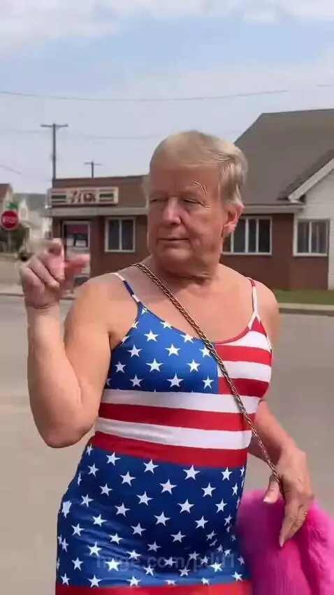 Person dressed as Donald Trump in a flag dress and heels dancing on a residential street.