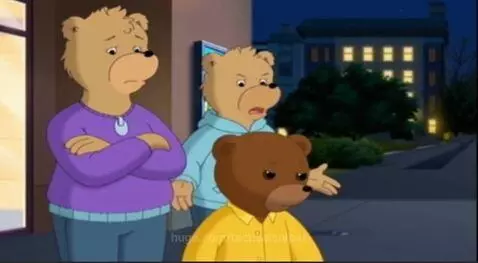 A sad young bear stands with its upset parents outside a cinema at night, after a firework incident.