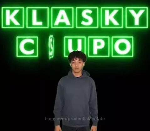 Man in hoodie with glowing green Klasky Csupo text on black background.