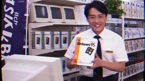 Man holding Binbows 95 box and woman looking at CRT monitor with Binbows 95 logo in a 1996 Japanese electronics store commercial.