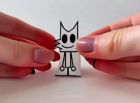 Close-up of hands squeezing a black and white squishy toy resembling a cat-like character.