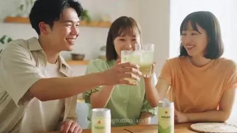 Three young adults toasting with glasses of Hikari Sparkling Green Tea, smiling and laughing.