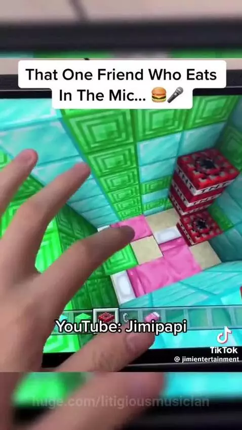 A gamer eating chips loudly into a microphone while playing a video game, annoying his friend.