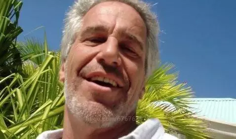 Man with gray hair and beard dancing energetically outdoors on a sunny day, smiling.