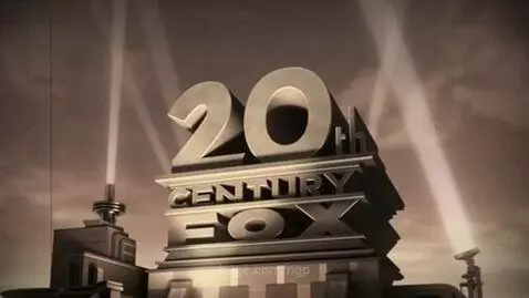 Monolithic, weathered concrete 20th Century Fox logo against a dark, cloudy sky with dramatic searchlights.